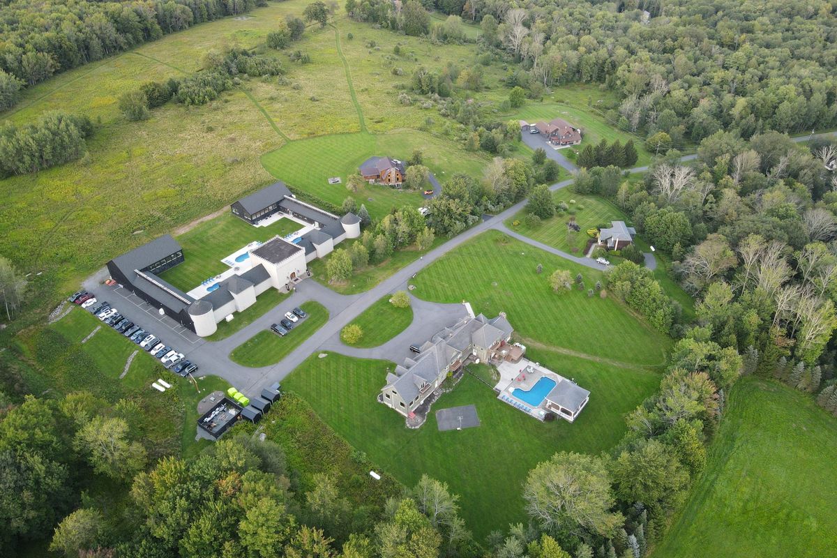The Castle from the air: the courtyard and pools, the car park along the west wing, and the Mansion across the road